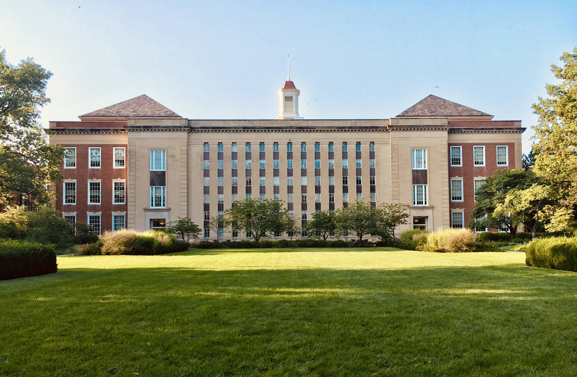Classic university building with green campus quad