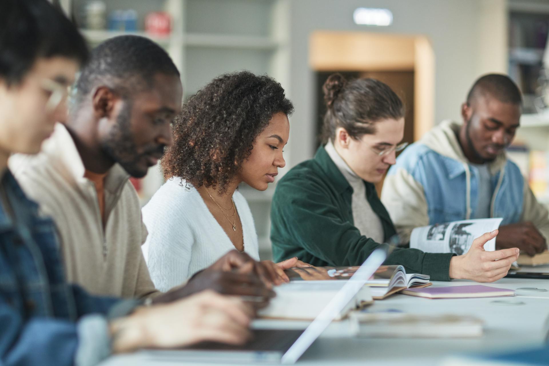 Diverse college students studying together in a university library
